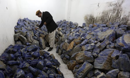 An Afghan businessman checks lapis lazuli at his shop in Kabul.