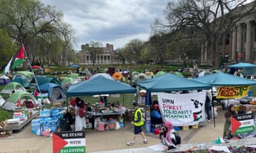 People and tents with Palestinian flags on lawn
