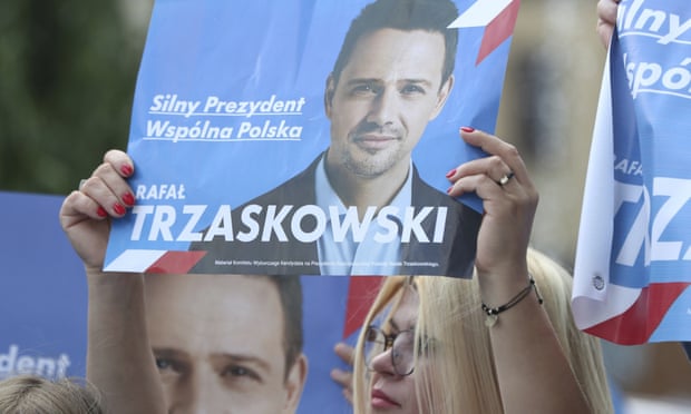 A supporter holds a poster of the presidential contender Rafał Trzaskowski at a campaign rally in Raciąż, Poland