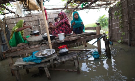 A family cooking amid floodwater in Lalmonirhat, Bangladesh, 2017.