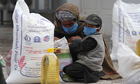 A family receives food rations amid lockdown in Herat, Afghanistan.