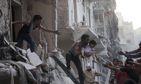 A man evacuates a child from a building following a reported barrel-bomb attack by Syrian government forces in the Shaar neighbourhood of the northern Syrian city of Aleppo.
