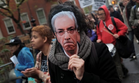A demonstrator wears a mask of Eduardo Cunha