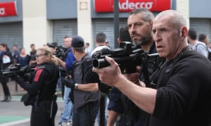 French riot police point teargas guns at football fans in Lille.