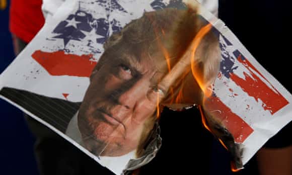 Student activists burn an image of President-elect Donald Trump during an anti-US rally outside the U.S. embassy in Manila, Philippines.