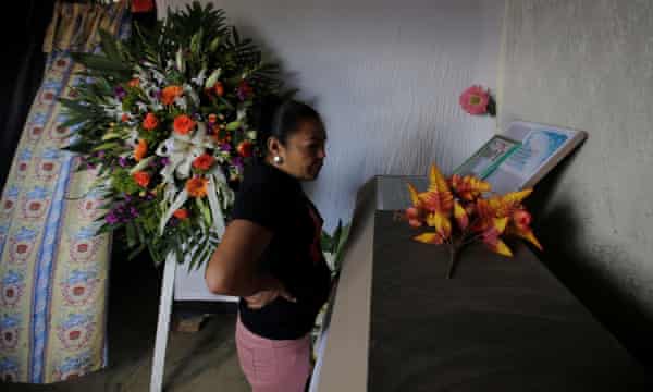 A woman looks at the coffin of Nelson Espinal during his funeral in Tegucigalpa, Honduras.