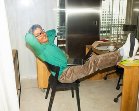 Smiling man with his feet up on desk