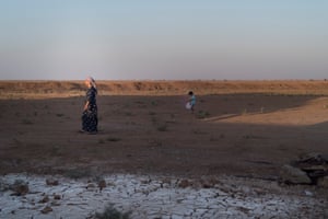 A woman and her child walking at sunset in the rural village of Dawdiyye, 10km north of Hasakah