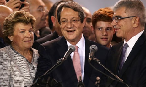 Nicos Anastasiades (centre) with his wife Andri and the chief returning officer, Kypros Kyprianou, during a proclamation ceremony in Nicosia