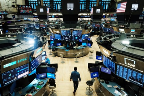 Traders work on the floor at the New York Stock Exchange on 20 March.