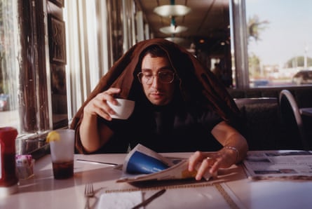 Jack Antanoff in a diner, drinking coffee and reading a newspaper