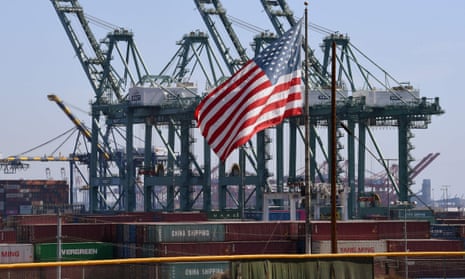 The US flag flies over Chinese shipping containers that were unloaded at the Port of Long Beach in California