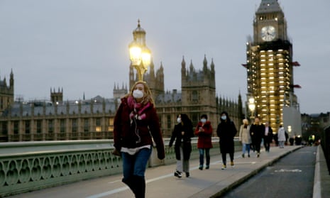 People wearing masks crossing Westminster Bridge.