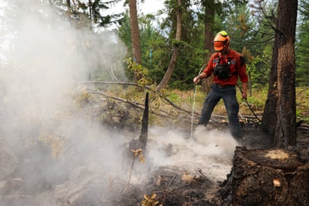 A firefighter works to control the south-eastern flank of the Bush Creek wildfire in Turtle Valley on 23 August, after it destroyed homes and other structures in multiple communities in the North Shuswap region of British Columbia.