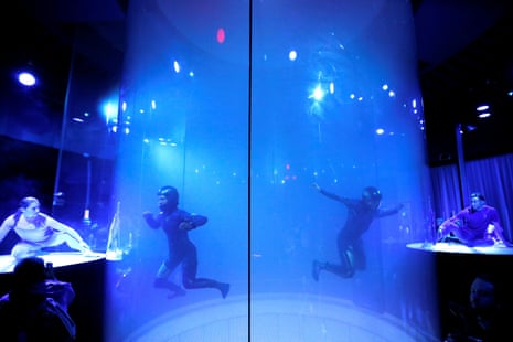 Models in a sky diving simulator wear Virgin Galactic's new space-wear system, developed in partnership with Under Armour, during an event to unveil the suits to be worn by future Virgin Galactic space travellers, in Yonkers, New York in 2019.