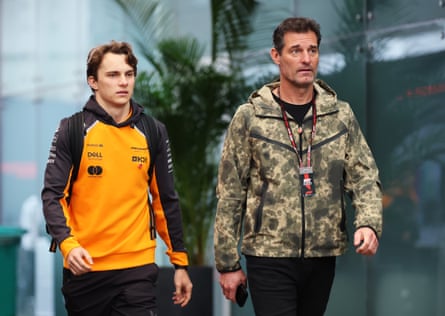 Oscar Piastri of Australia and McLaren and Mark Webber arrive in the Paddock prior to the Sprint ahead of the F1 Grand Prix of Brazil