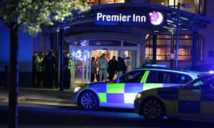 Armed officers guard outside the Premier Inn hotel near the Manchester Arena