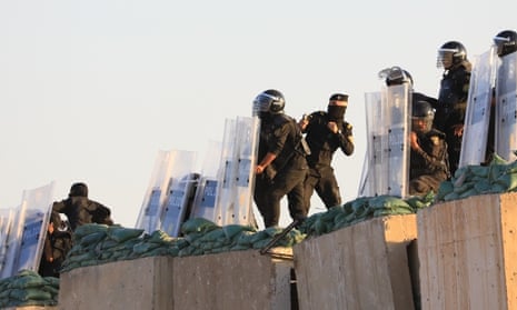 Protesters try to break through barriers on the Republic Bridge in Baghdad, Iraq during a day of anti-government demonstrations