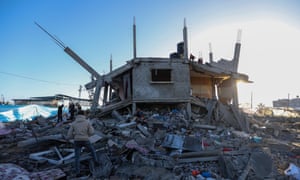 People inspect damage and recover items from their homes after Israeli airstrikes