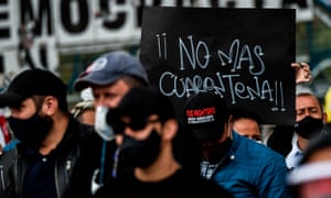 Shopkeepers and business owners protest against coronavirus lockdown measures in Bogota, Colombia, with a banner saying ‘No more quarantine’.