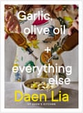 Front cover of a cookbook called Garlic, olive oil and everything else, featuring two hands pouring olive oil into a baking dish of garlic cloves.
