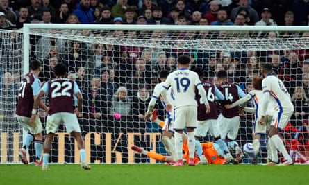 Marco Asensio of Aston Villa (left) watches as Filip Jörgensen fails to stop his shot.