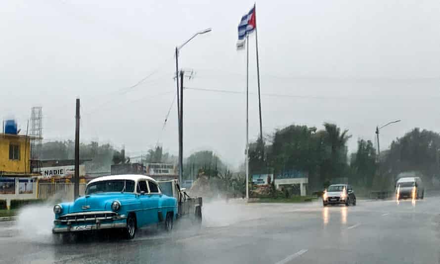 People drive under the rain in Havana on Friday as Hurricane Ida passes through Cuba.