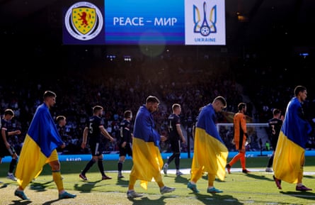 The Ukraine players walk out draped in flags before the World Cup play-off semi-final match against Scotland at Hampden Park.