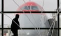 A passenger walks between a fountain and a Northwest Airlines Boeing 747 in Detroit<br>A passenger walks between a fountain and a Northwest Airlines Boeing 747 at the Detroit Metropolitan Wayne County Airport February 2, 2006. Northwest Airlines is currently restructuring in bankruptcy. REUTERS/John Gress jumbo40