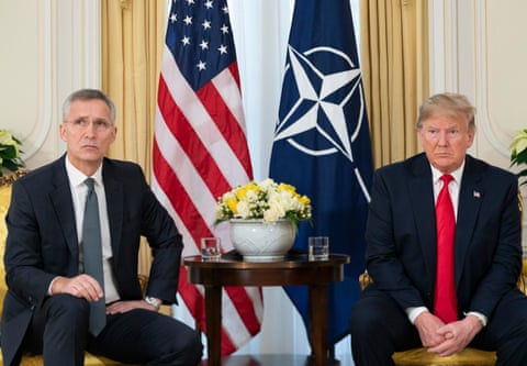 Jens Stoltenberg, then general secretary of Nato, and US president Donald Trump, sitting either side of a table, American and Nato flags hanging behind them, in 2019