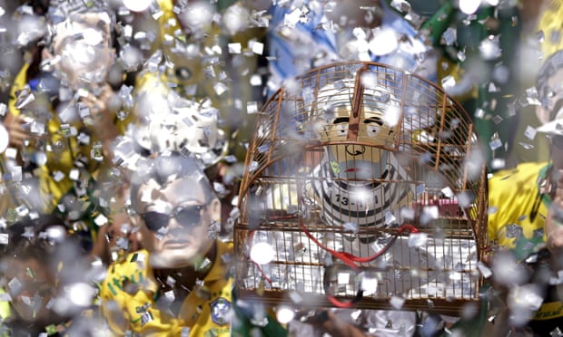An inflatable doll known as “Pixuleco” of Silva is seen inside a cage during a protest in BrasiliaAn inflatable doll known as “Pixuleco” of Brazil’s former President Luiz Inacio Lula da Silva is seen inside a cage during a protest against Brazil’s President Dilma Rousseff, part of nationwide protests calling for her impeachment, near the Brazilian national congress in Brasilia, Brazil, March 13, 2016. REUTERS/Ueslei Marcelino