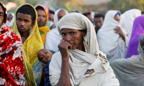 A woman stands in line to receive food donations at the Tsehaye primary school in the town of Shire, Tigray region.