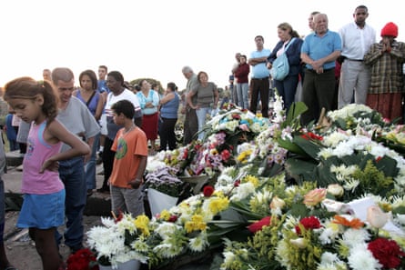 people standing next to flowers