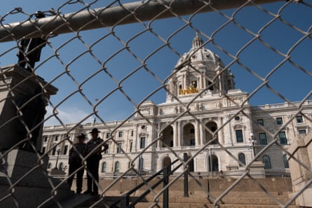 Minnesota capitol building seen through a chain link fence
