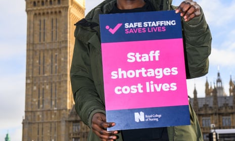 A Royal College of Nursing strike banner that reads 'Staff shortages cost lives'