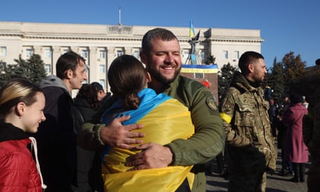 A woman hugs a Ukrainian soldier in Kherson.