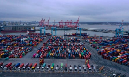 Shipping containers are stacked in a port.