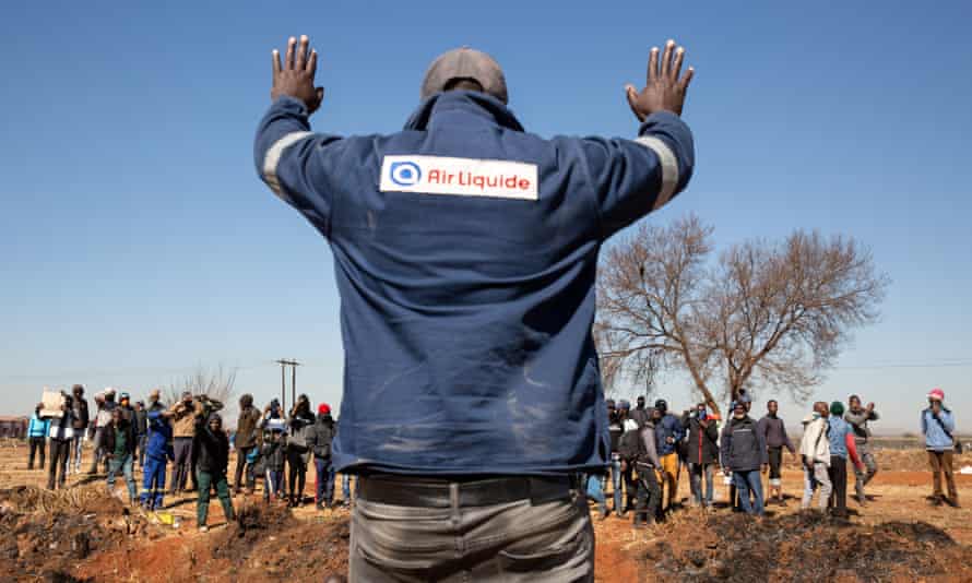 A community member appeals to the crowd for calm in Vosloros, Johannesburg, South Africa.