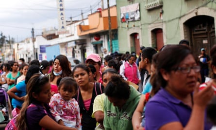 Residents queue for food at a collection center after the earthquake in Xochimilco.