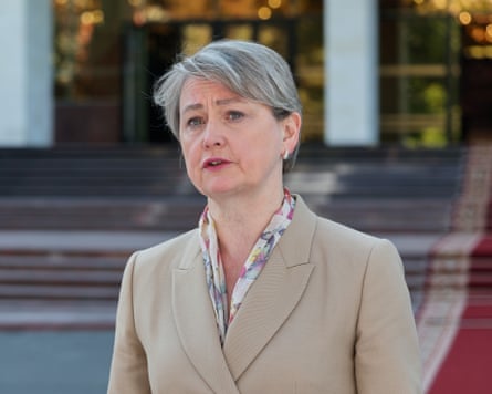 Yvette Cooper in a beige jacket on steps of an official building.