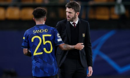 Michael Carrick has a quiet word with Jadon Sancho after the final whistle.