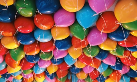 Helium-filled balloons stuck against a ceiling.