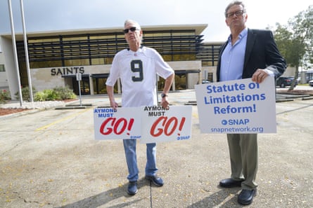 Members of Snap, the Survivors Network of those Abused by Priests, including Richard Windmann, left, and John Gianoli, right, hold signs during a conference in front of the New Orleans Saints training facility in Metairie, Louisiana, in 2020.