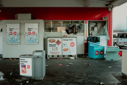 Smashed windows and goods strewn about at a petrol station