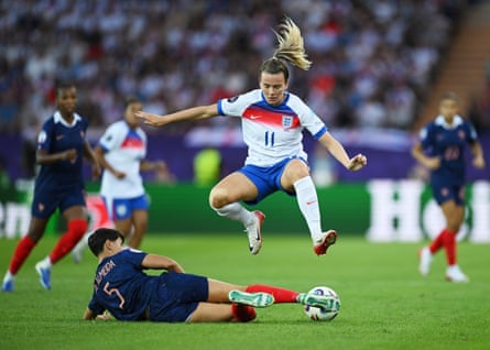 Lauren Hemp of England is challenged by Élisa De Almeida of France.