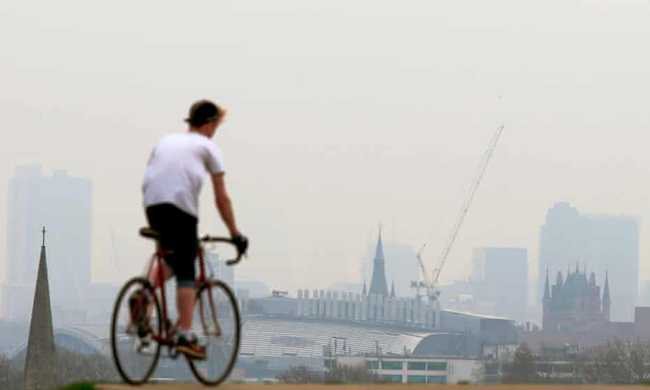 A cyclist riding his bike on Primrose Hill in London.