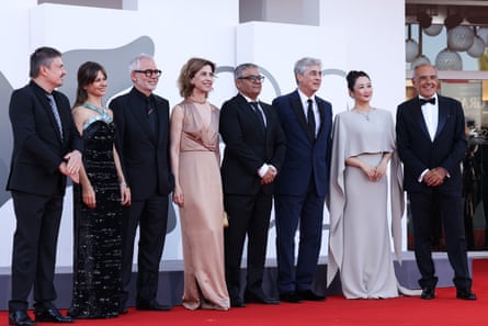 Jury members Cristian Mungiu, Maura Delpero, Stéphane Brizé, Fernanda Torres, Mohammad Rasoulof, Alexander Payne, Zhao Tao and festival director Alberto Barbera at the closing ceremony.