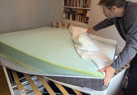 A man removes the cover from a Panda Hybrid Bamboo Mattress