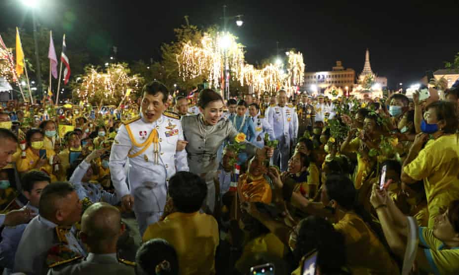 King Maha Vajiralongkorn and Queen Suthida greet supporters outside the Grand Palace in Bangkok