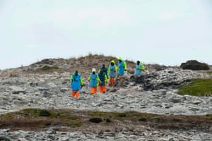 Zimbabweans work on a mined beach in Stanley